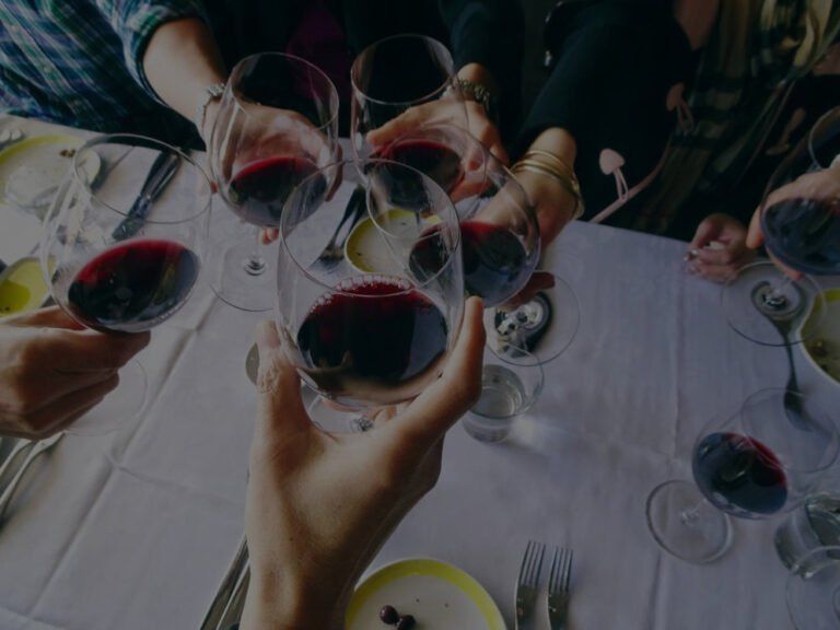 Wine Maven | cheers happy mothers day lots of glasses of red wine clinking together real life candid celebration